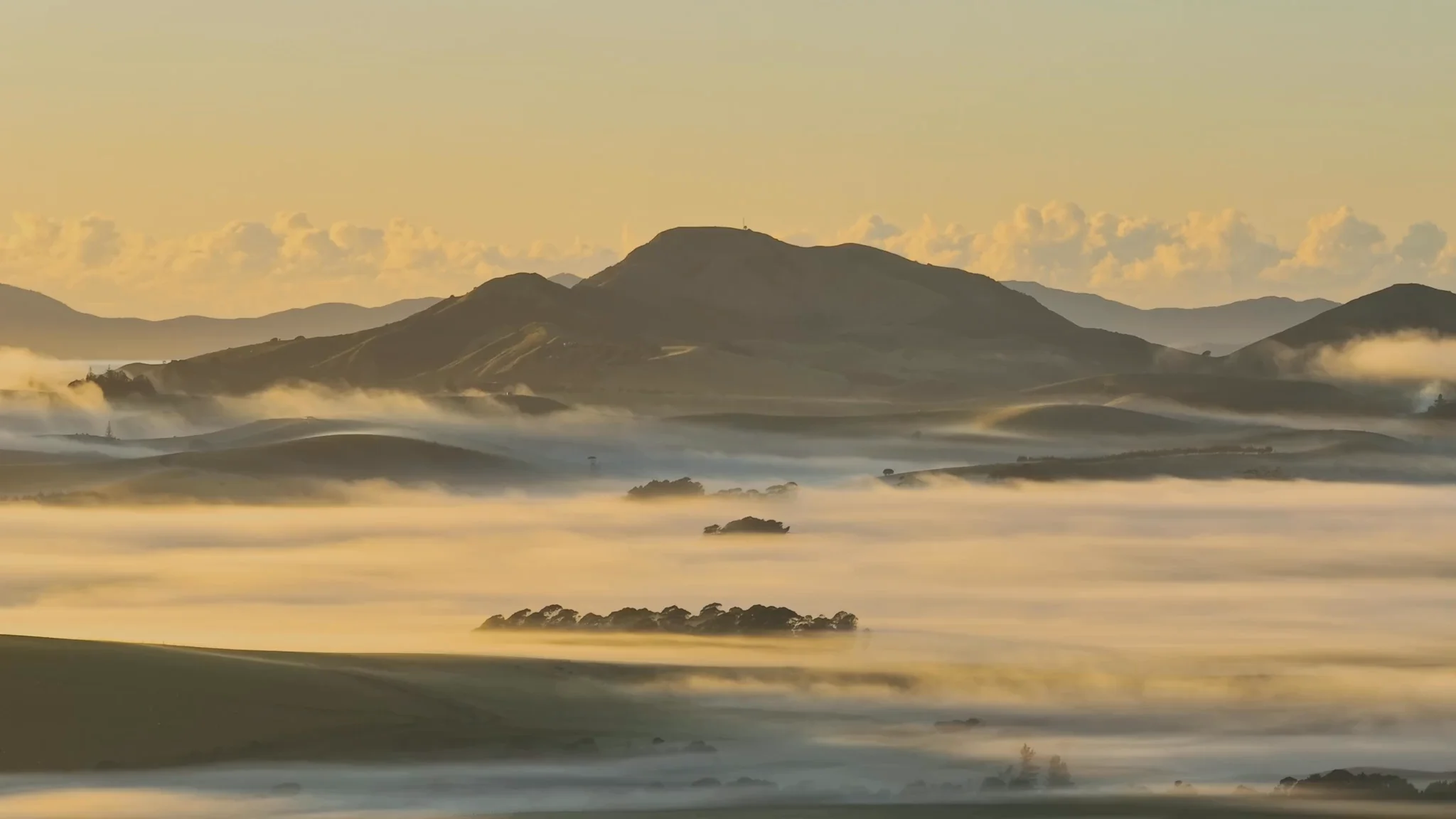 Golden mist rolling through Mataka Station's valleys at sunrise