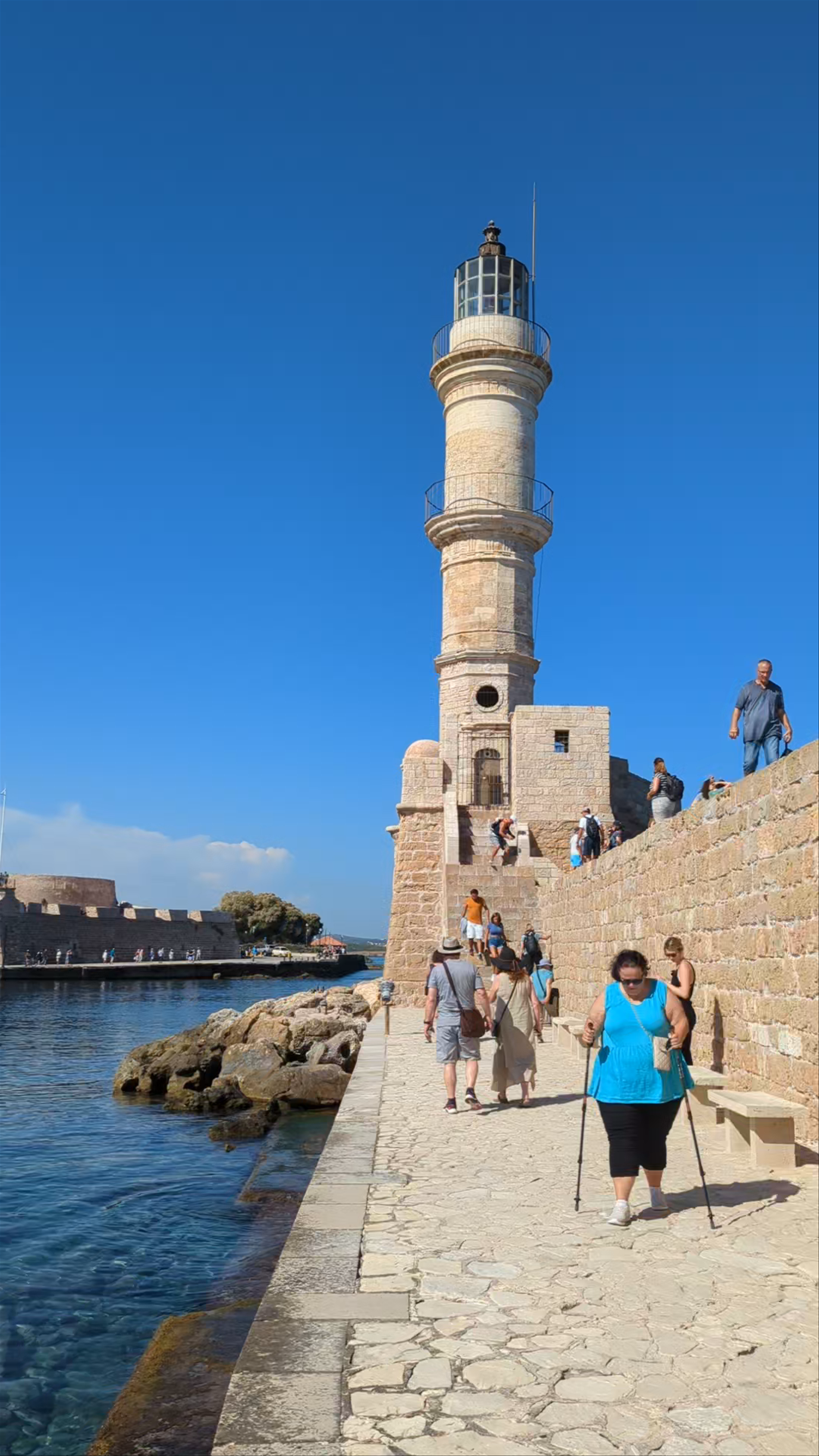 Lighthouse of Chania: Sunlit Serenity on Crete’s Historic Harbor