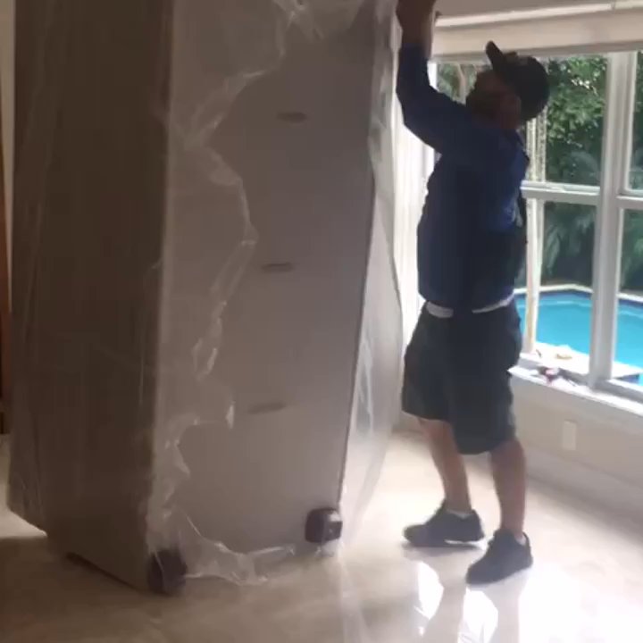 Oscar's Moving And Storage - Pro Mover packing a sofa - Movers Near Me - Miami, Florida