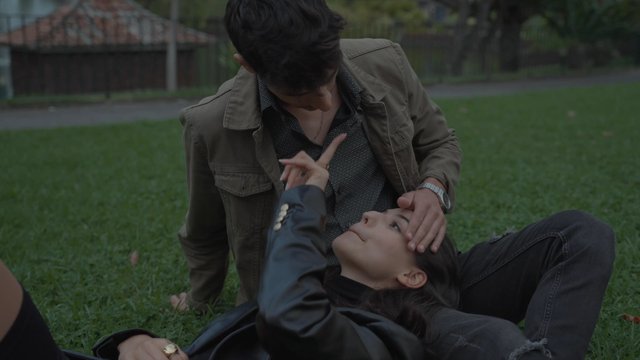 A guy gently strokes his girlfriend’s hair