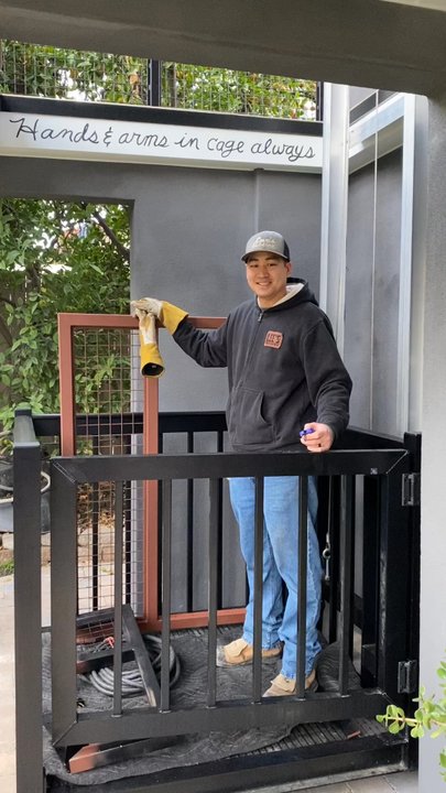 Lee's Welding - David in our elevator/cargo lift hoisting up the safety gate. When elevator is on the ground floor leaves an open shaft in 2nd. story deck. - Metal Fabricators Near Me