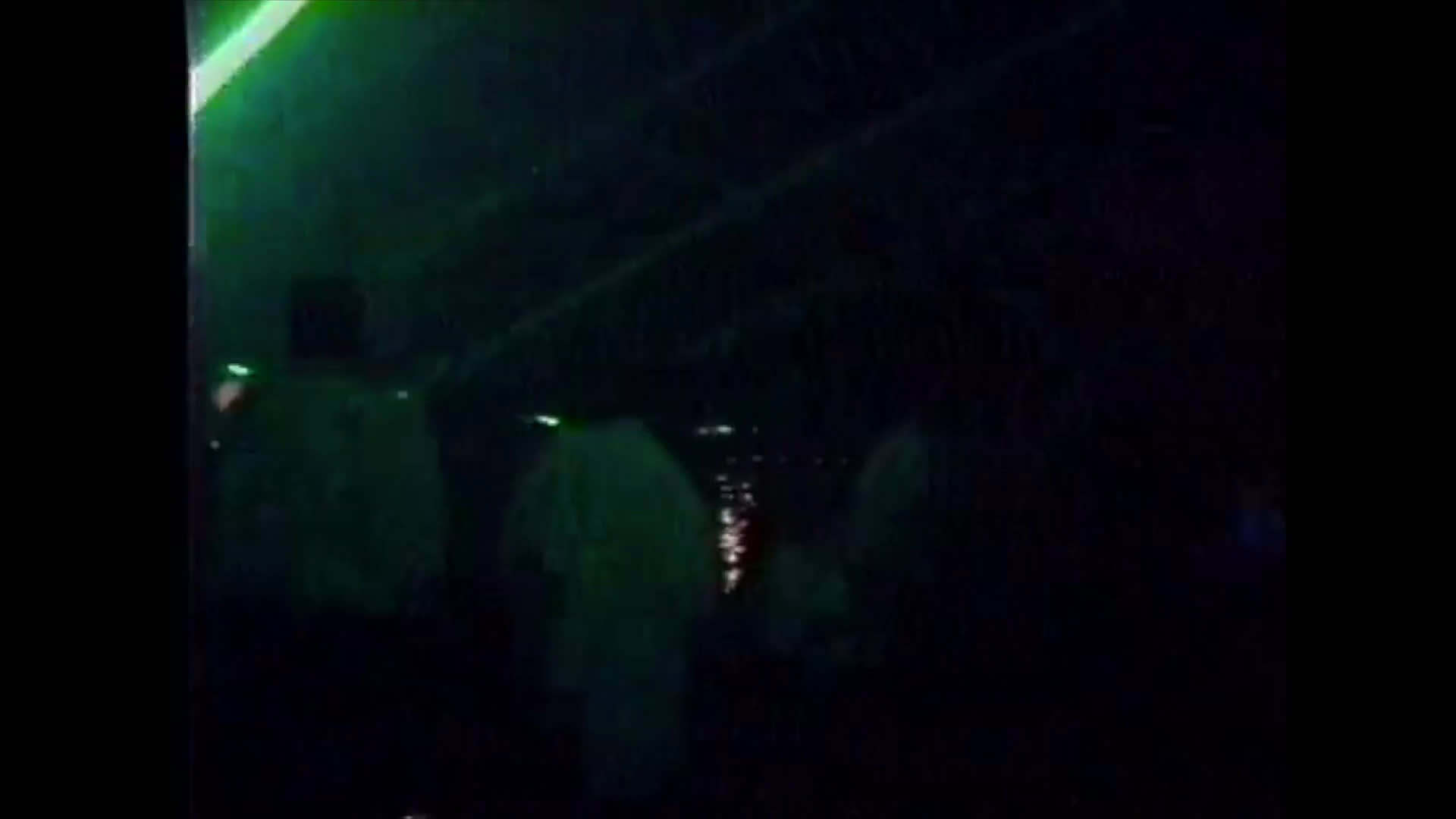 A wheelchair user navigates a lively, laser-lit nightclub dance floor among a crowd of people. The sequence transitions to an outdoor setting, capturing the individual in a bright, open environment.
