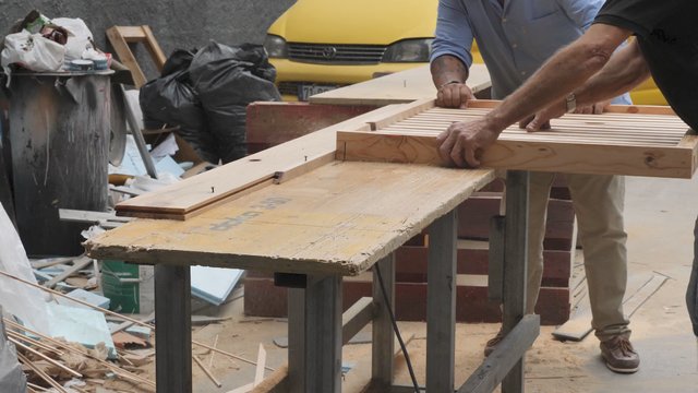 Carpenter sawing wood