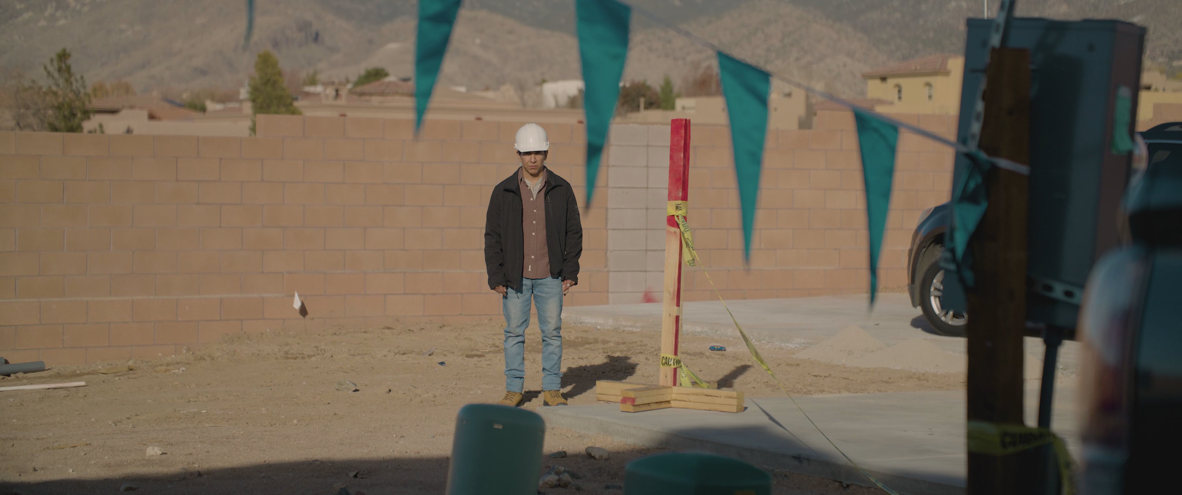 A woman arrives at a suburban residence and experiences a tense moment upon entering, while a man observes from the exterior.