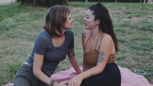 Lesbian couple talking and kissing