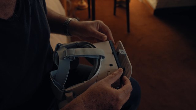 A man putting a smartphone into a VR headset