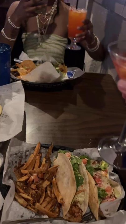 Shuckers Raw Bar - Cheers-ing drinks over the shrimp tacos and shrimp nachos - Bars Near Me - Myrtle Beach, South Carolina