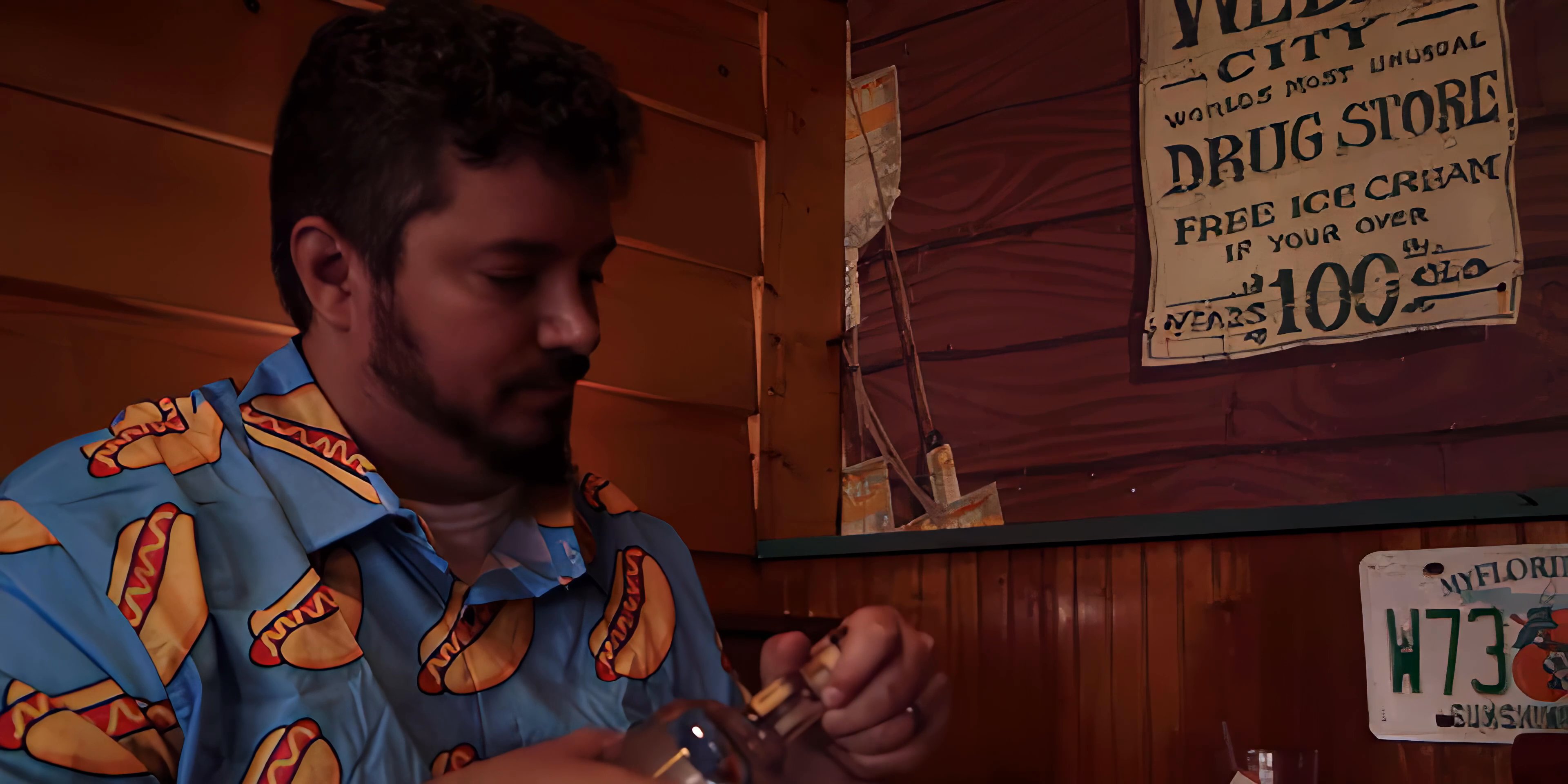 Two individuals engage in conversation while one prepares a beverage in a vintage-themed bar setting.