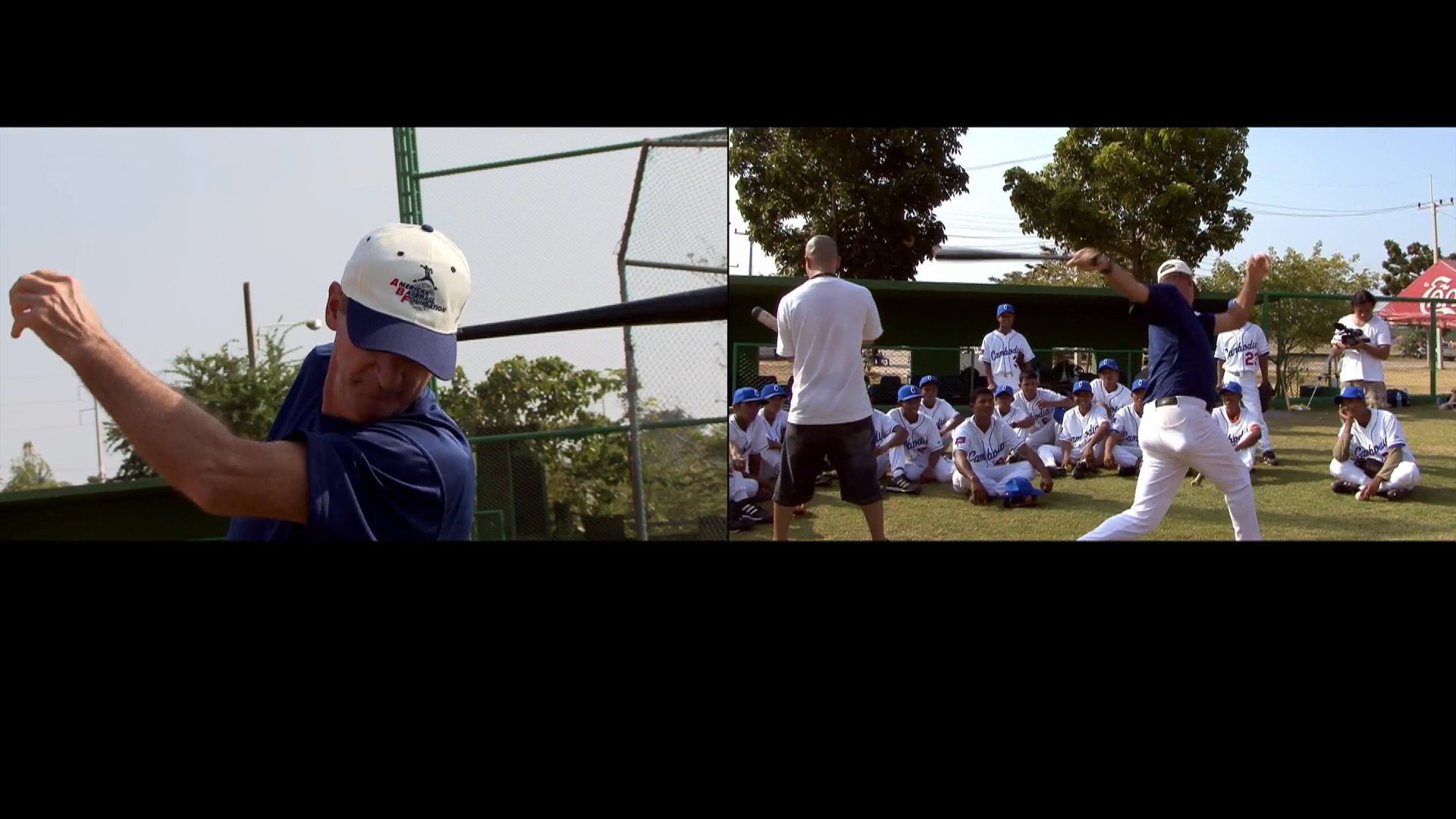 A coach demonstrates proper batting techniques to a group of attentive baseball players on an outdoor field. The session focuses on swing mechanics and stance adjustments for athletic development.