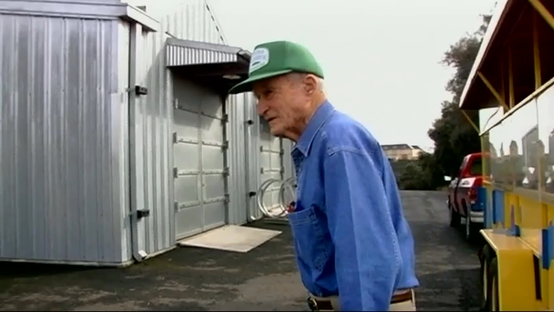 An 85-year-old former San Francisco Chronicle reporter carefully steps down from a yellow-and-blue trailer, then enters a gallery with another man. They view a collection featuring three sculptural figures, including the piece David Best considers its best.