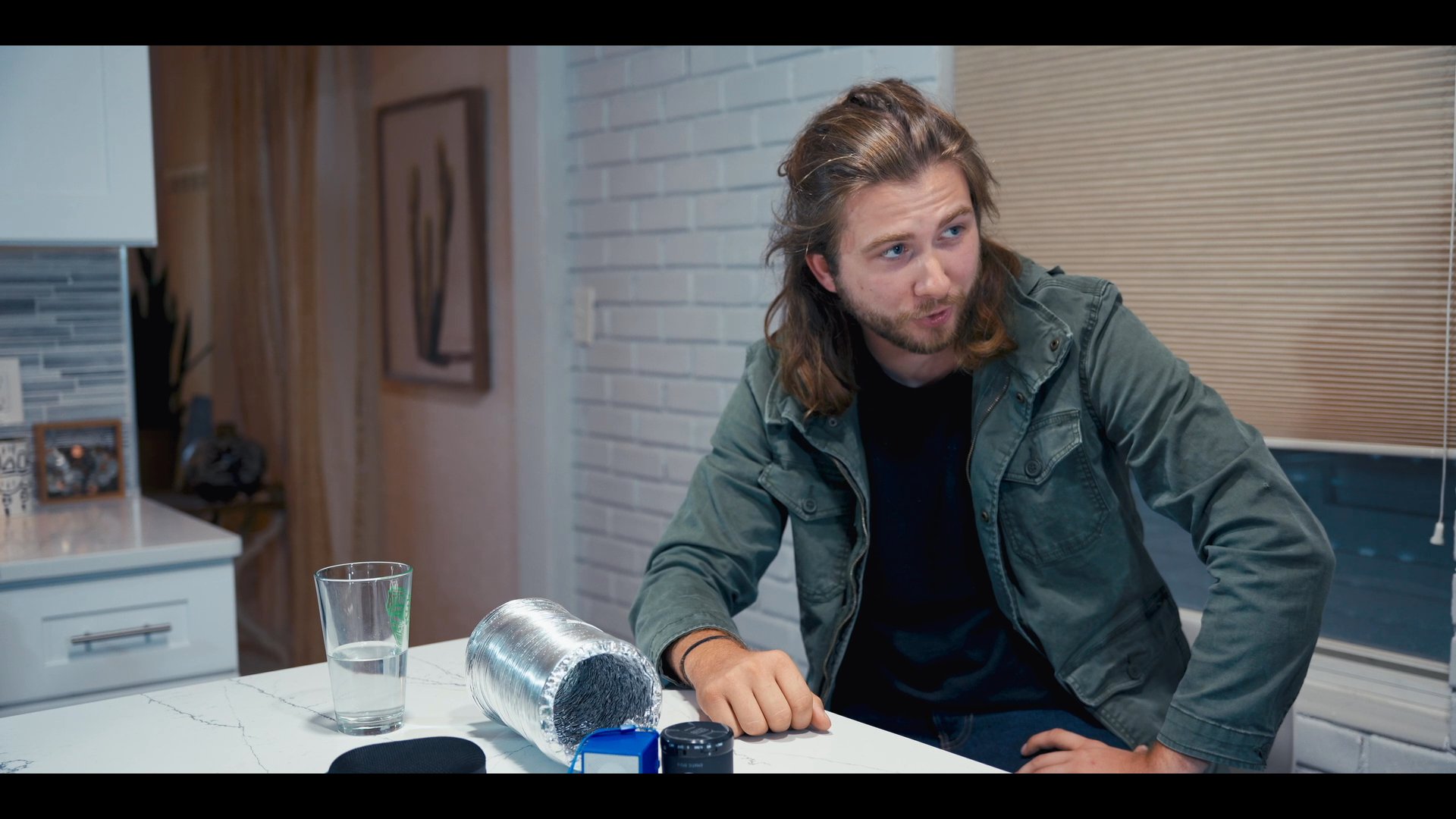 Two individuals engage in a focused, seated conversation within a well-lit residential environment, alternating between speaking and active listening.