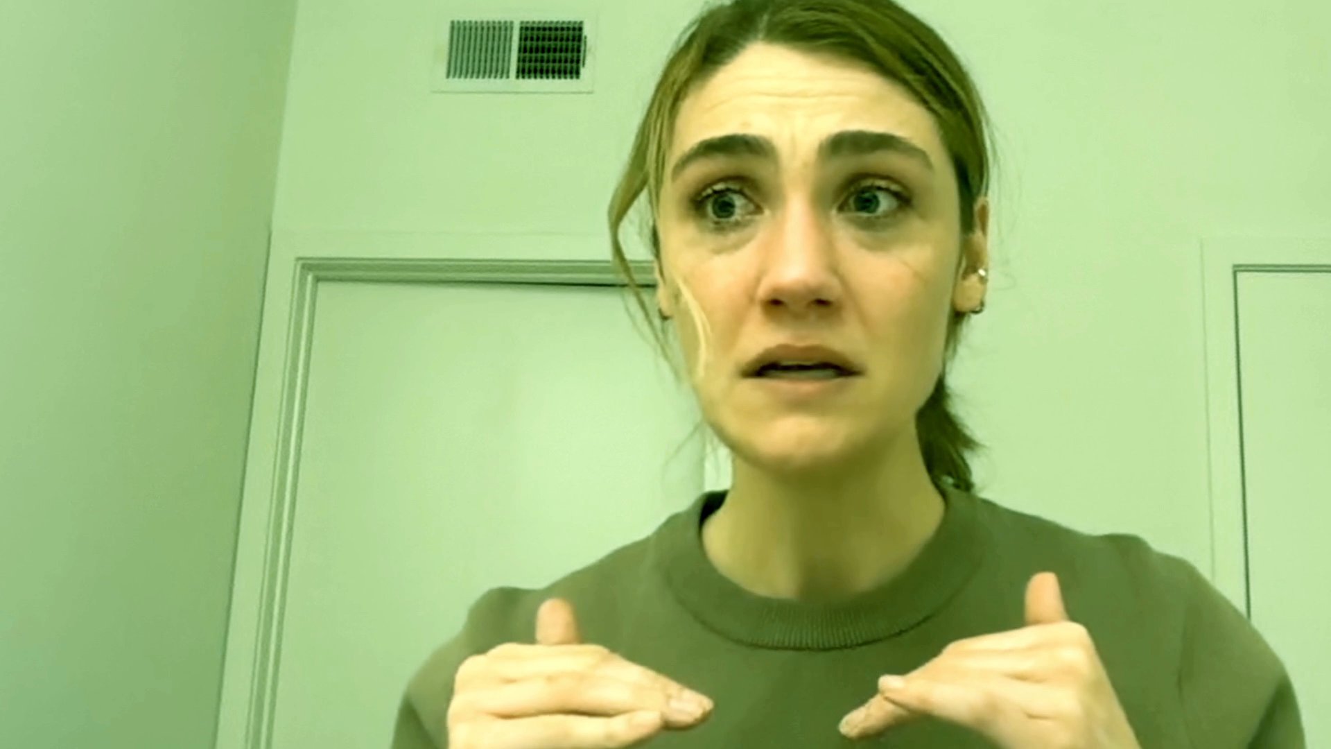 A woman performs a series of intense, shifting emotional expressions directly toward the camera. Her facial movements convey a rapid range of complex reactions and dramatic storytelling.