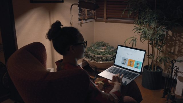 A girl browsing the NFT marketplace while sitting on an office chair