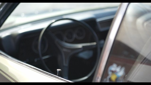 Window and steering wheel of a vintage Dodge