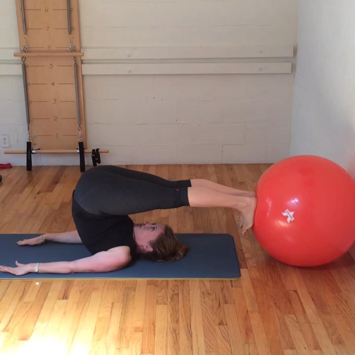 Aligned Pilates Studio - Control balance with the ball - Pilates Near Me