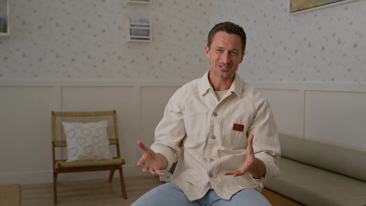 Dr. Quinn smiling during his interview in the Milk Tooth lobby