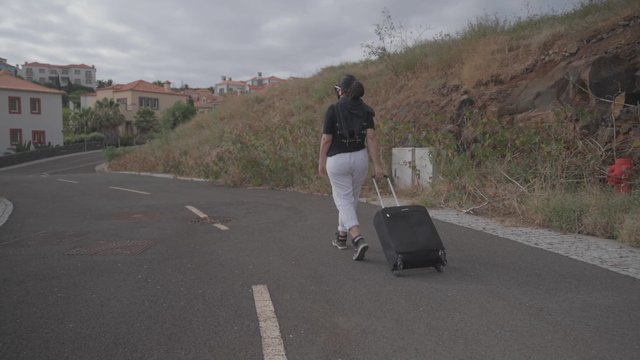 Woman walking with a suitcase