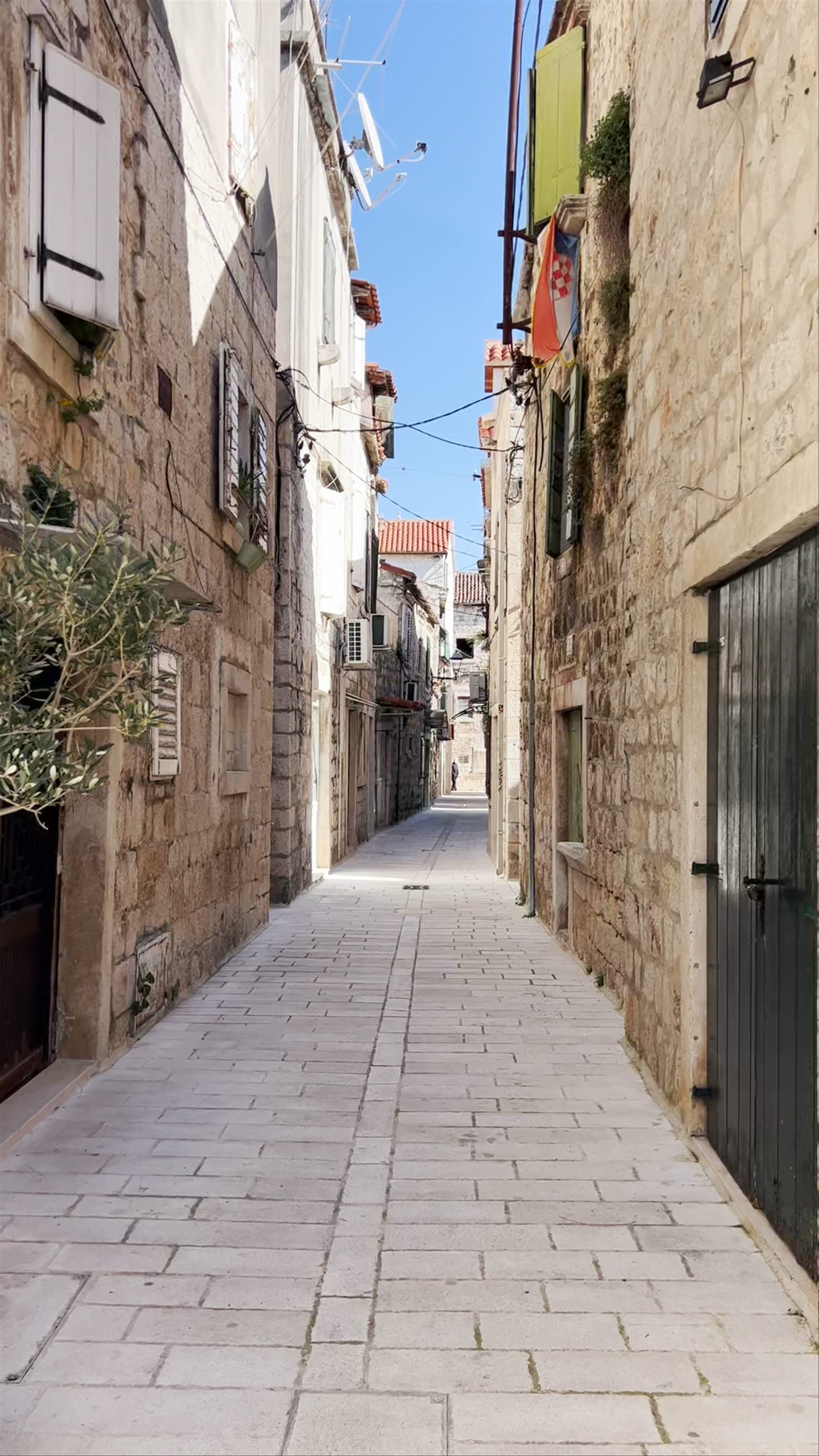 Sunlit Stroll Through Trogir Old Town's Timeless Alleyways