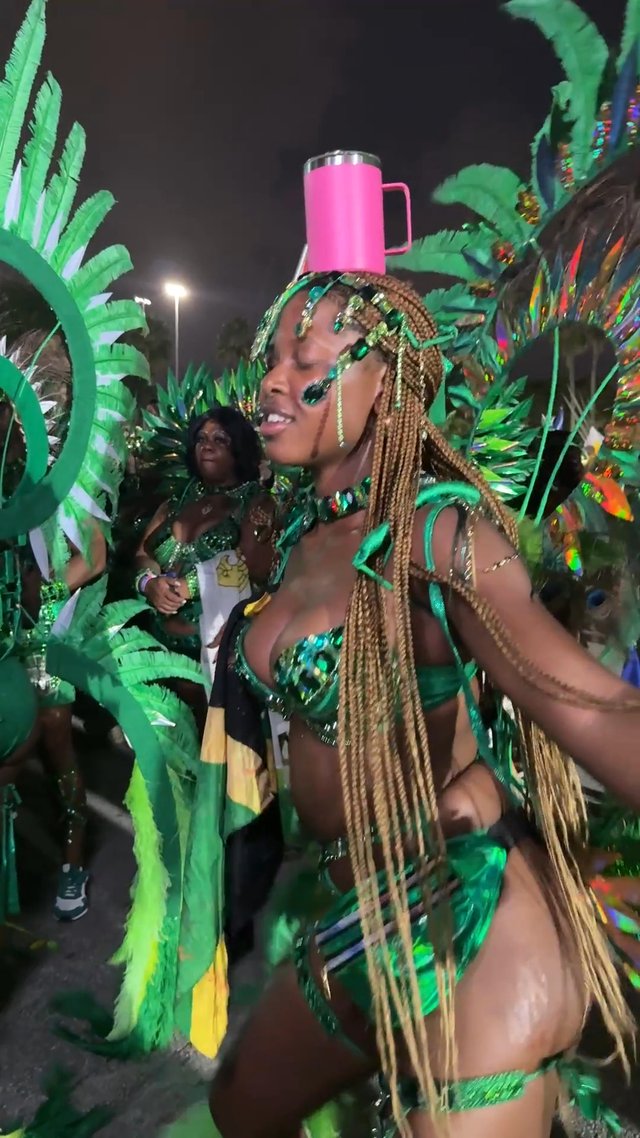 SHE IS DANCING WITH A CUP ON HER HEAD.......