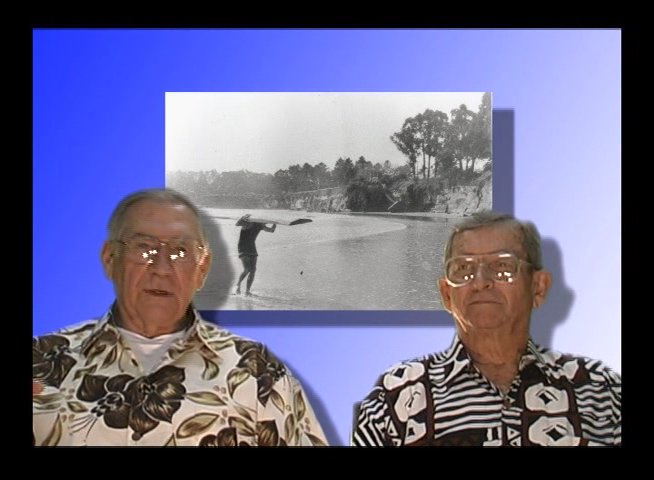 Two senior men discuss past experiences while vintage black-and-white archival footage plays behind them. The segment transitions from a conversational studio setting to full-screen historical landscape imagery.