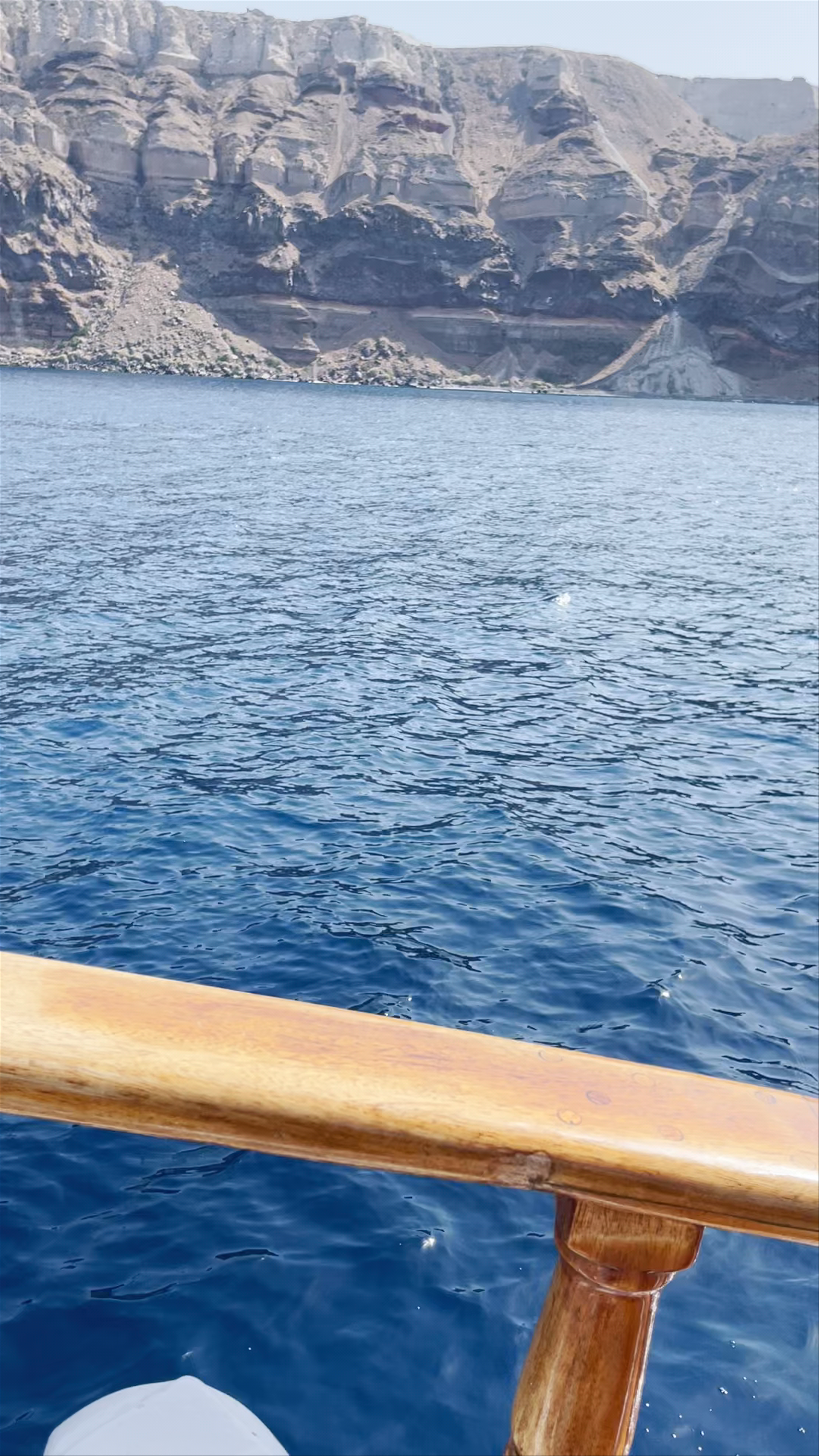 Santorini Sea Voyage: Majestic Cliffs and Deep Blue Waters