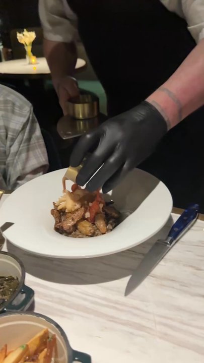 Le Moyne's Chophouse - The sauce being poured over the lobster risotto and also the ribeye being sliced and served between us. - Steakhouses Near Me - Mobile, Alabama