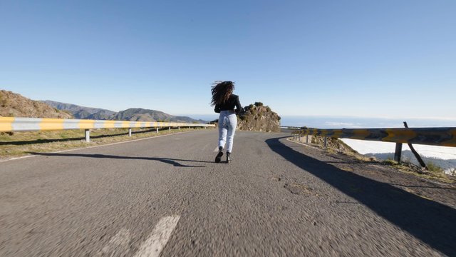 Woman running down a road