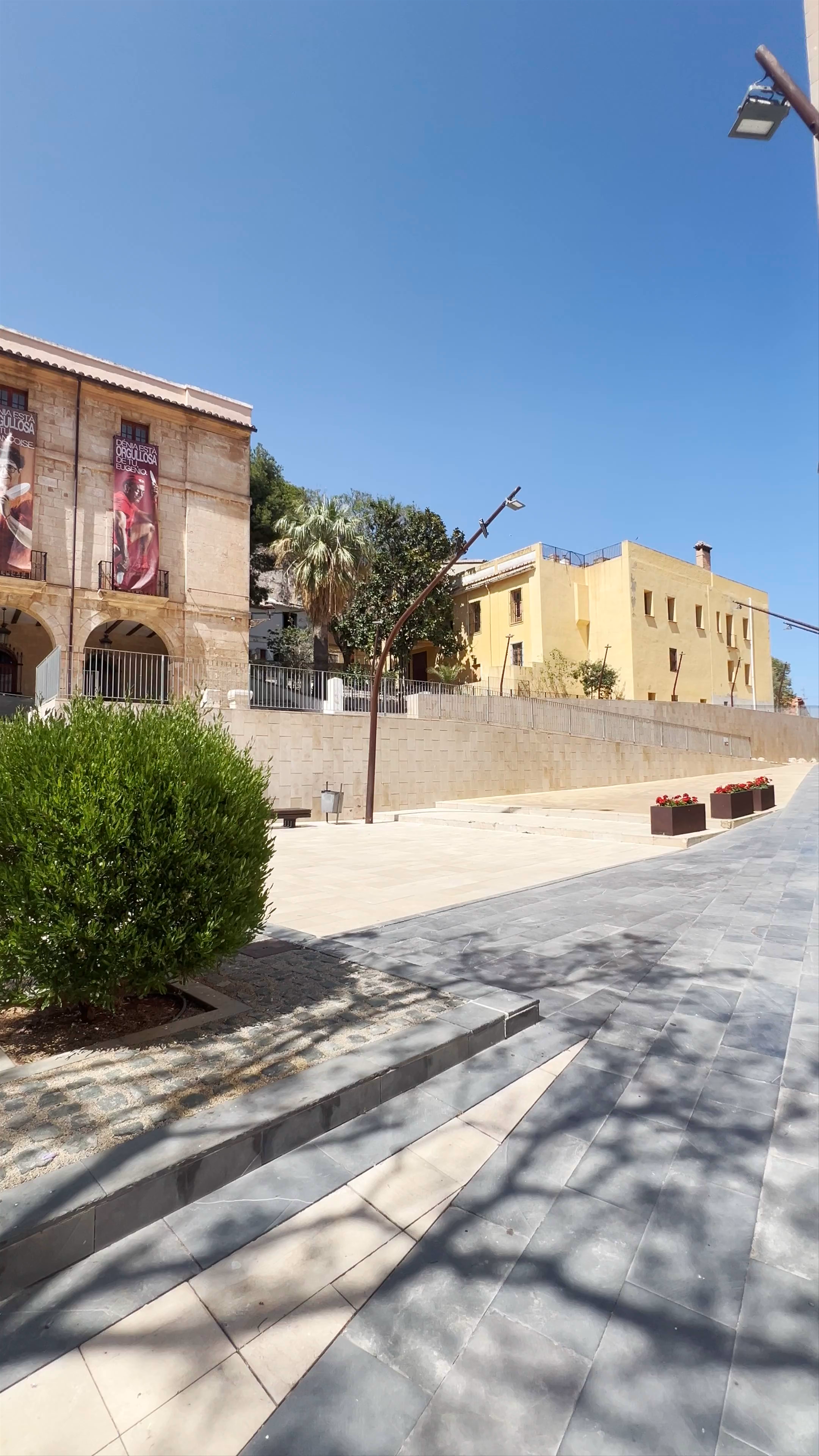 Sunlit Plaza and Ayuntamiento de Dénia: A Historic Spanish Town Experience
