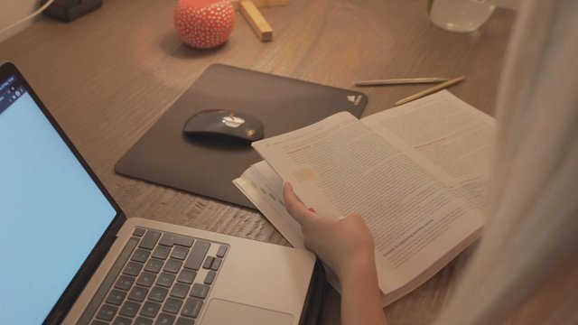 Woman sitting at her desk and studying at home