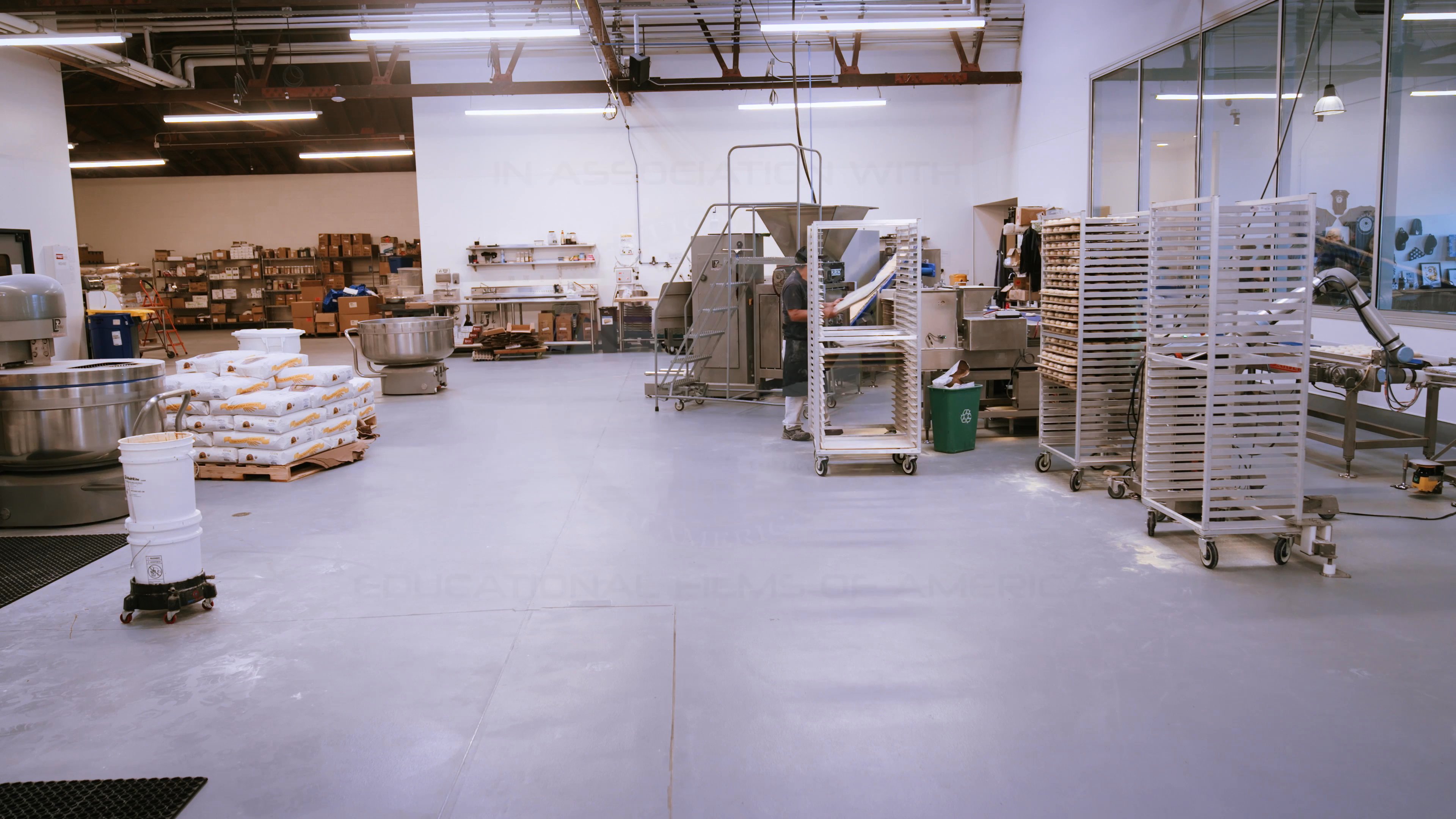 Production logos for SouthPaw Productions and Educational Films of America appear against an industrial kitchen backdrop, followed by a close-up of heavy-duty mixing machinery.