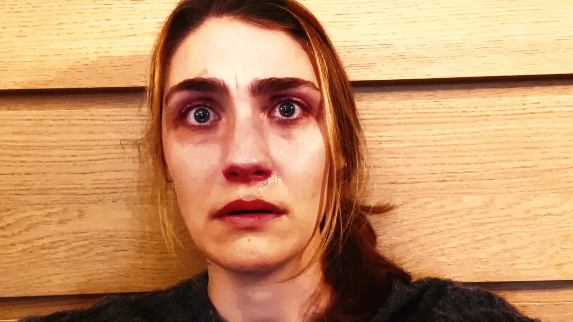 A woman exhibits a range of intense facial expressions, transitioning through visible emotional distress and weeping.