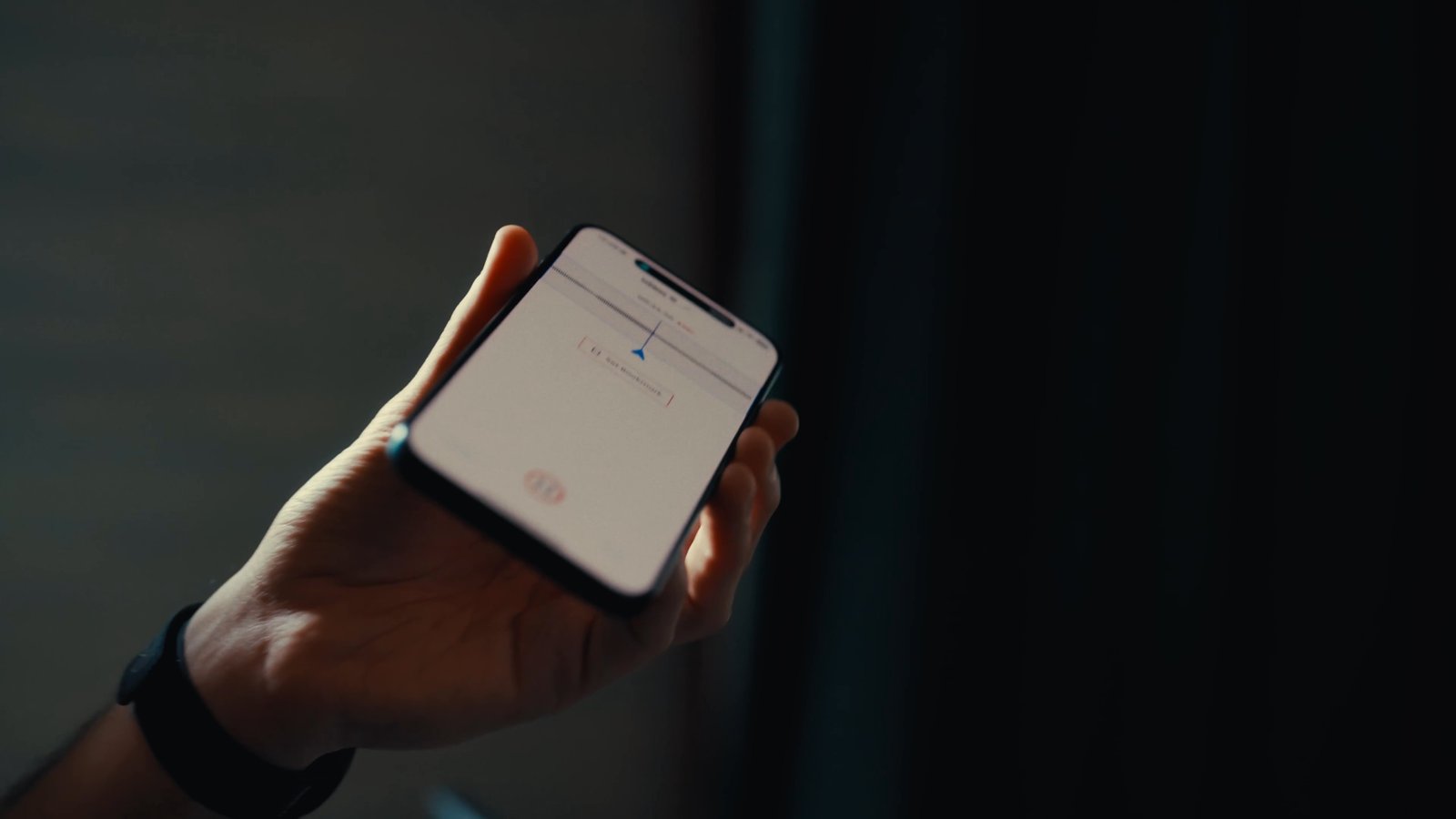 A songwriter holding a phone with a Cord recording open