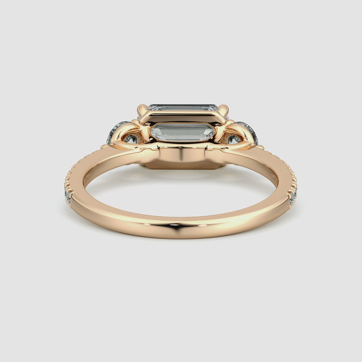 The Three Stone | Emerald | 14k | Rose Gold | bandAccent: Pavé | diamondOrientation: horizontal | sideStoneCarat: 0.25ct | sideStoneShape: Round Brilliant | caratWeight: other