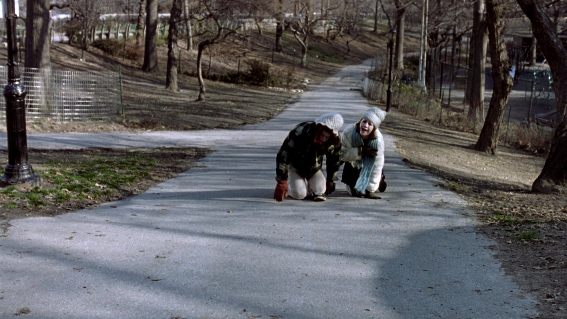 Family members enjoy a casual gathering in a park during the colder months, transitioning from archival portraits to candid outdoor activity and conversation.