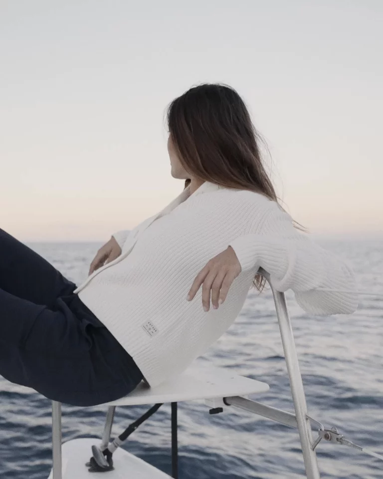 Woman lounging on a boat at sunset