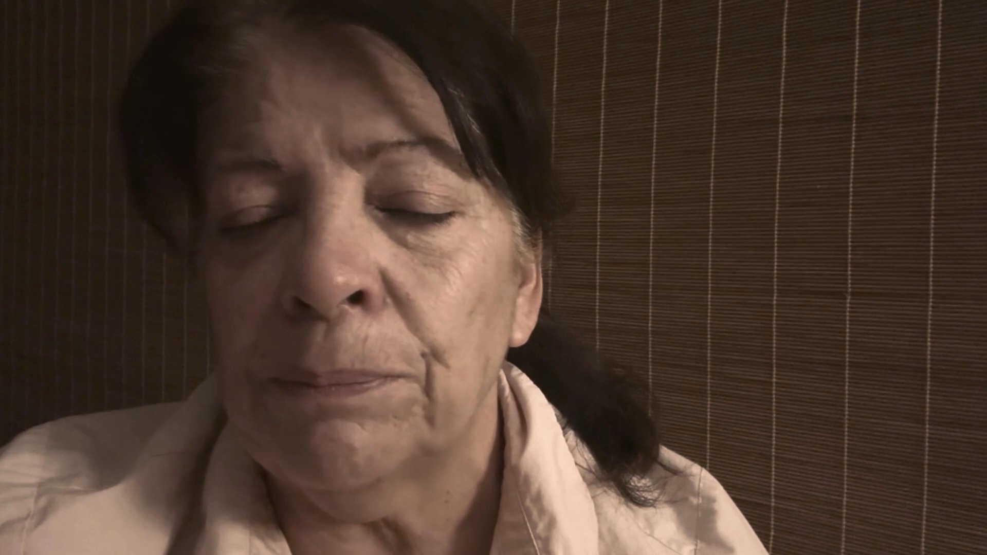 Two women display visible signs of deep sorrow and emotional distress in individual close-up sequences. Their facial expressions and tearful eyes convey a sense of personal mourning or profound sadness.