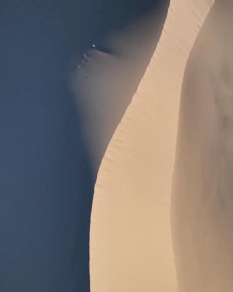 Drone video of sand dunes showing light and shadowed areas