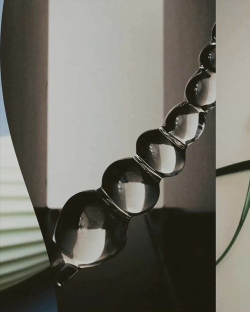 Soft pink sculptural forms and metallic product details for the Afterglo brand, set against pale blue and beige surfaces
