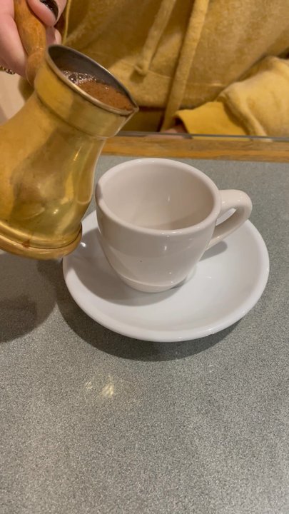 Holy Land Cafe - Poured a bit too much, but this Turkish coffee with cardamom spices was delicious!! - Middle Eastern Near Me - Lenexa, Kansas