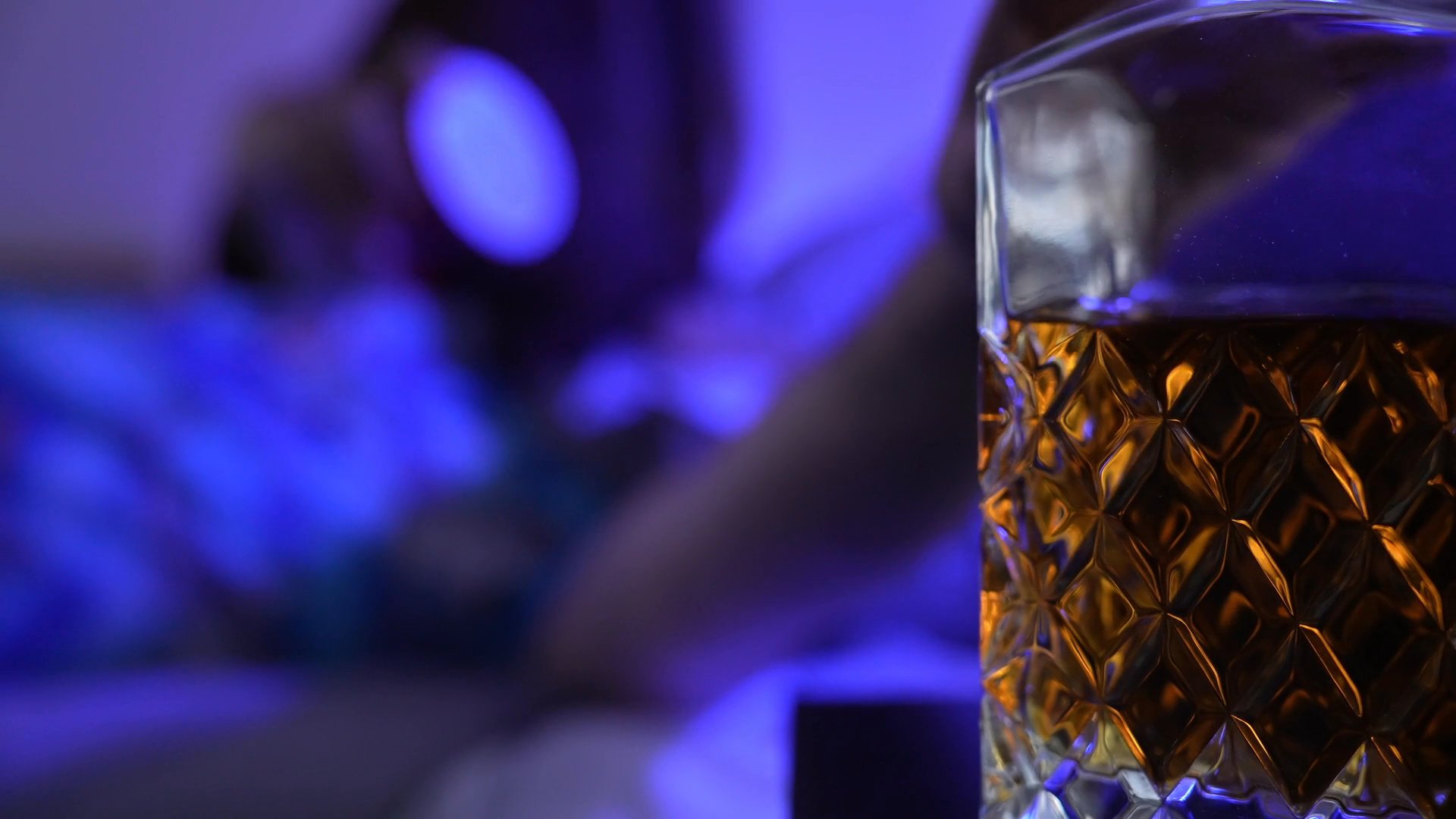Individuals engage in a playful prank during an evening social event in a home setting. The narrative transitions from a brightly lit interaction to a dark, suspenseful moment in a bedroom before returning to the group in the living area.