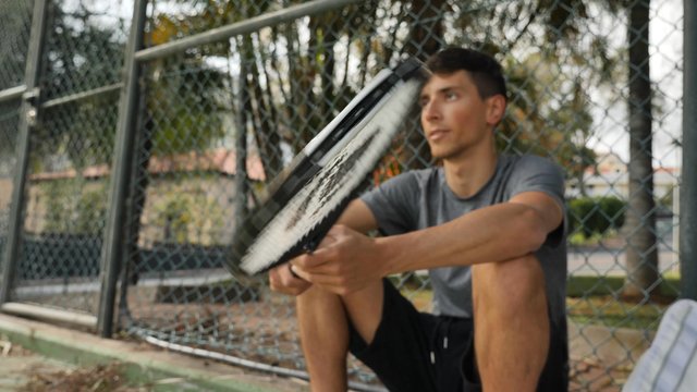 Man spinning a tennis racket