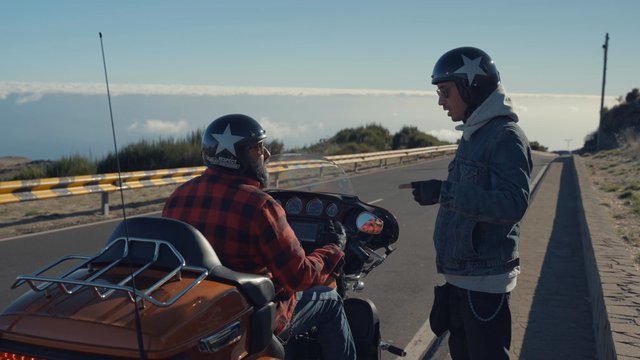 Two bikers discussing things