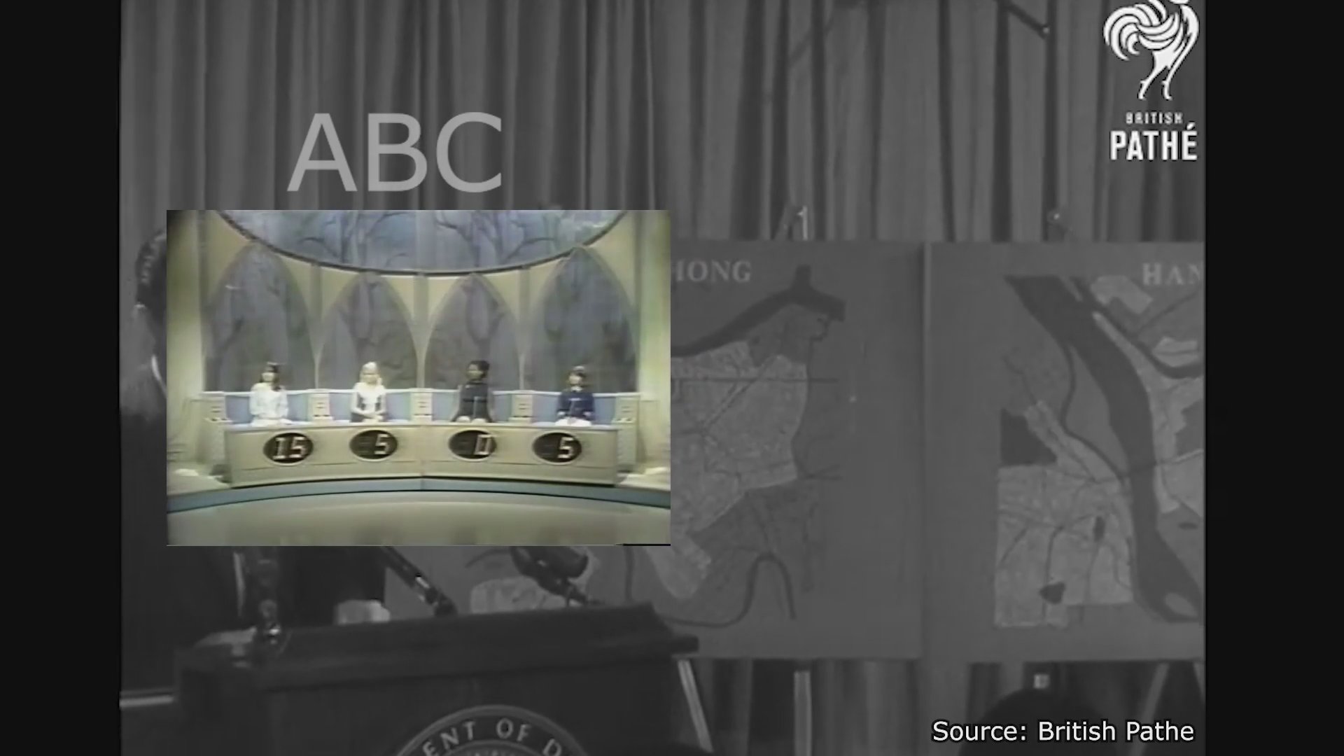 A military official presents strategic maps of Vietnam during a formal press briefing, which is subsequently shown in side-by-side television news broadcast segments.