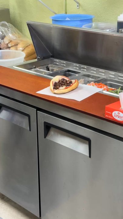 Banh Mi Saigon - The owner of making the sandwich - Vietnamese Near Me - Pinellas Park, Florida