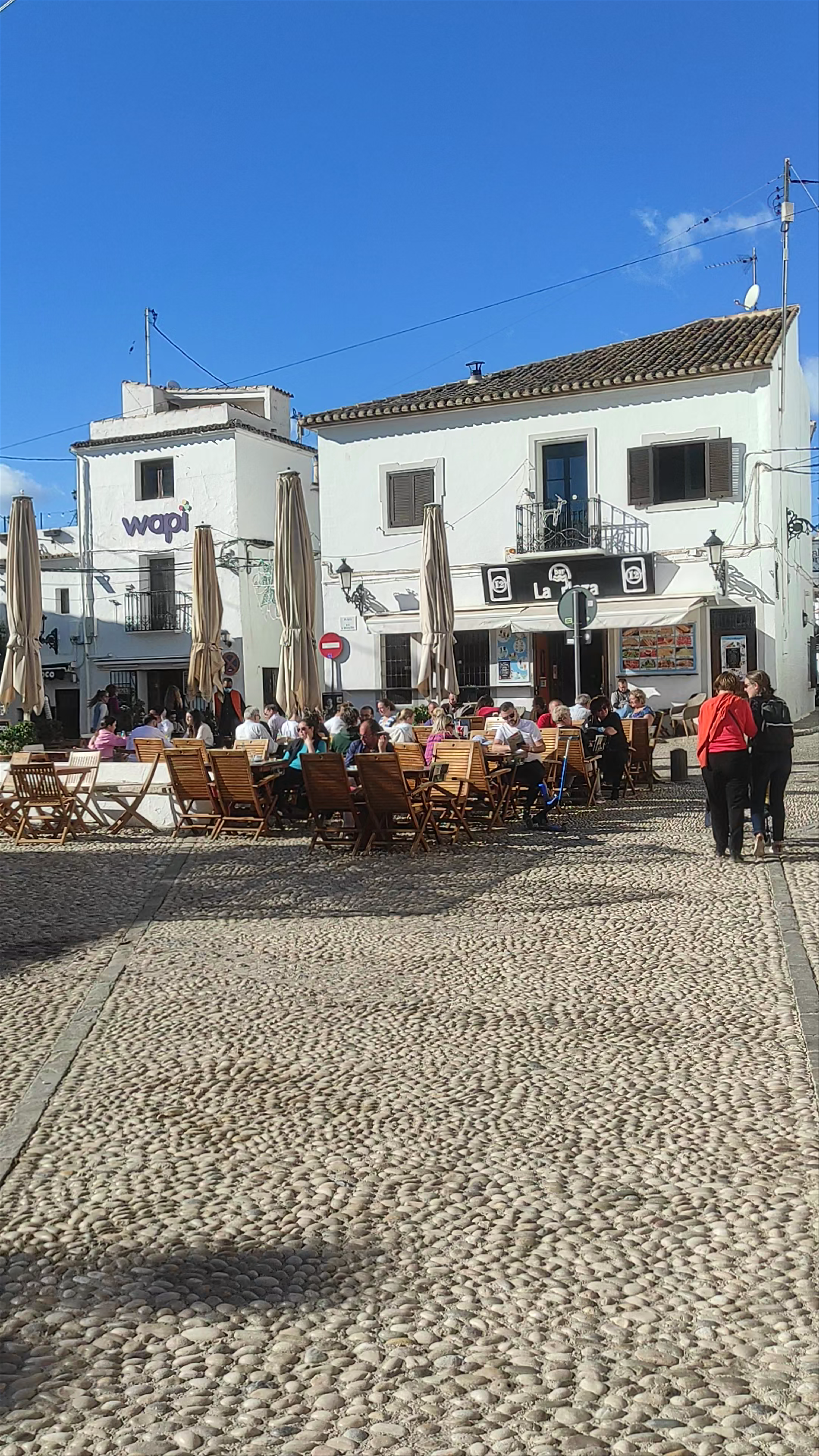 Sunlit Plaza de la Iglesia: A Charming Spanish Village Square
