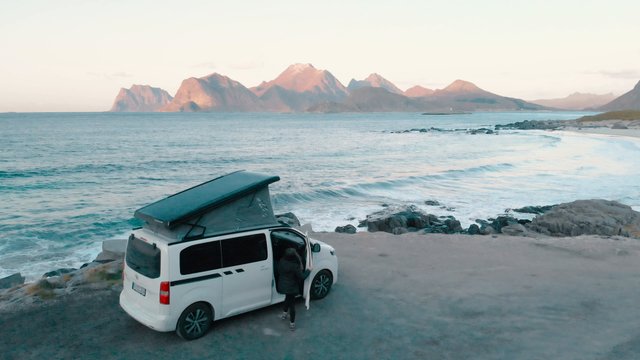 Woman gets out of campervan