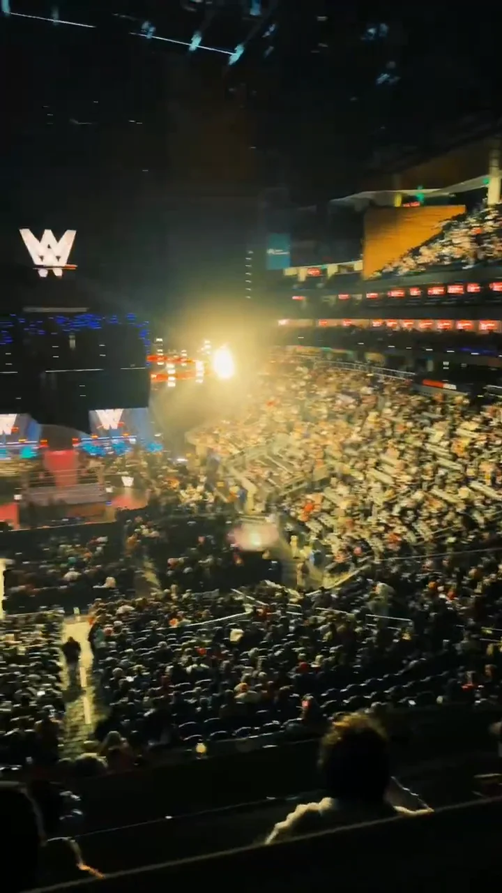A packed State Farm Arena crowd under purple stage lights during WWE Monday Night Raw