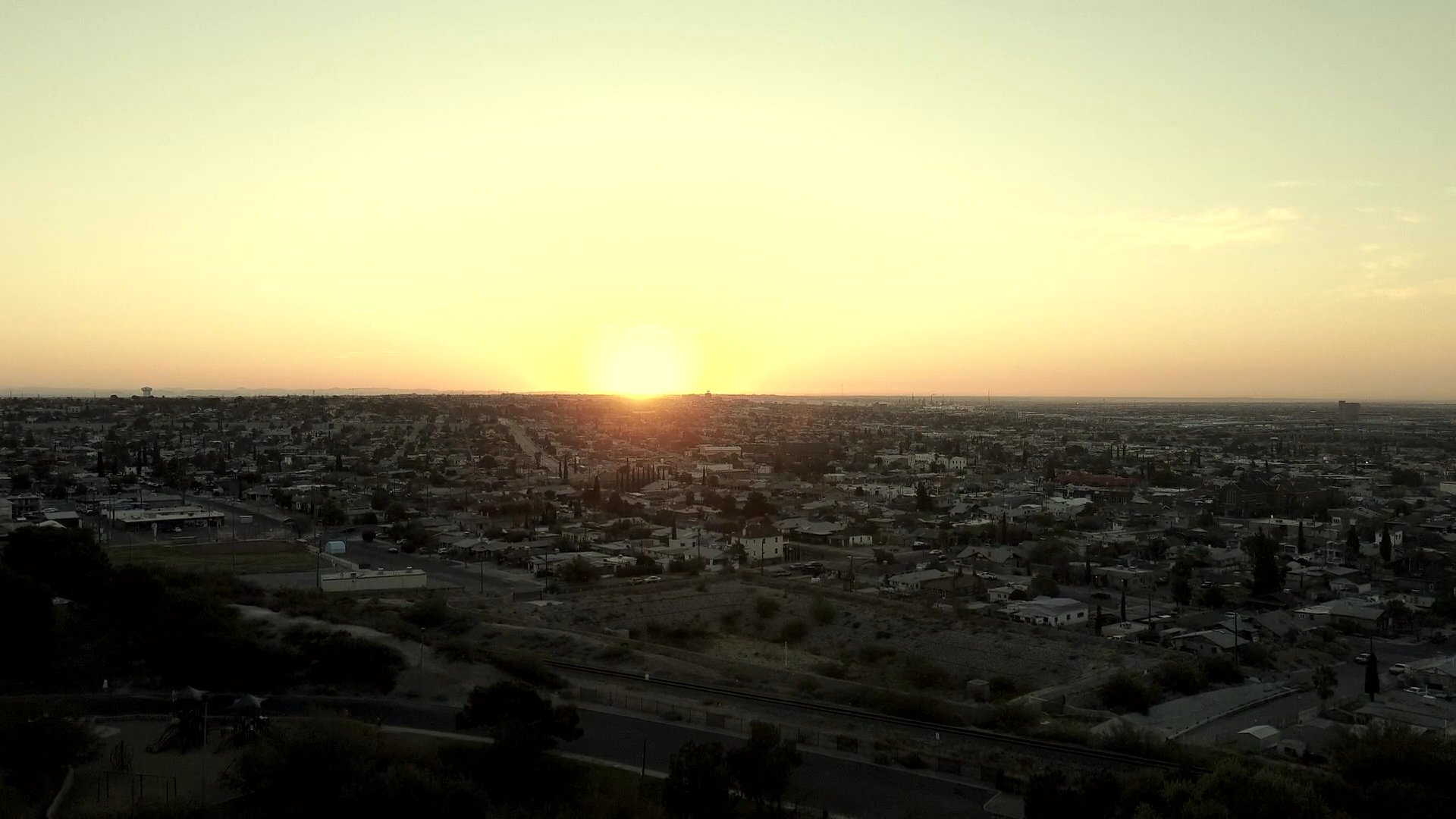 An introductory title sequence reveals the name of the project over a sprawling city at sunset, followed by a silhouette looking out over the urban horizon. The scene transitions to a brief temporal note marking a passage of time.