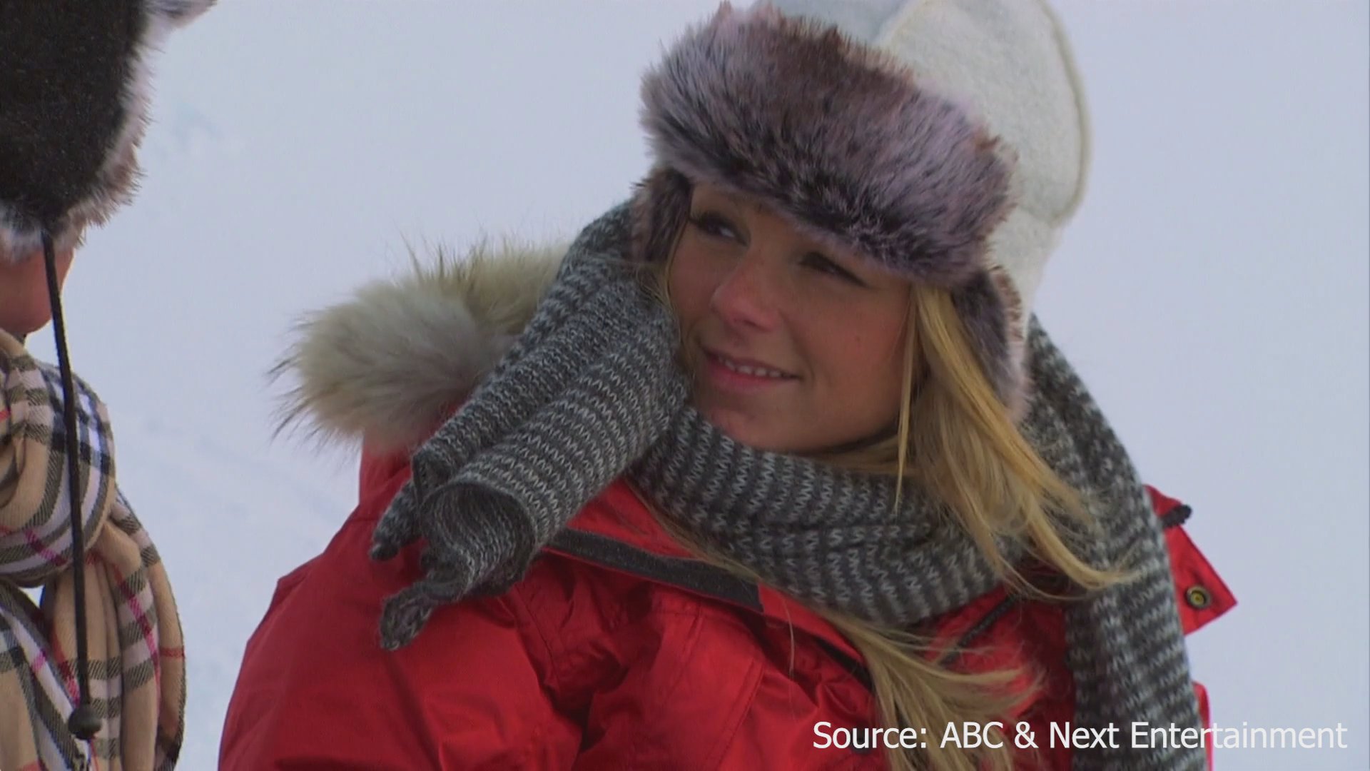 A couple sits together in a snowy environment, engaging in a heartfelt conversation about sincerity and trust while intercut with a contestant's individual interview segment.