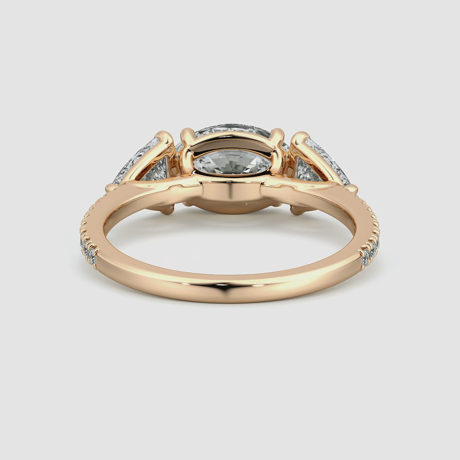 The Three Stone | Oval | 14k | Rose Gold | bandAccent: Pavé | diamondOrientation: horizontal | sideStoneCarat: 0.50ct | sideStoneShape: Trillion | caratWeight: other